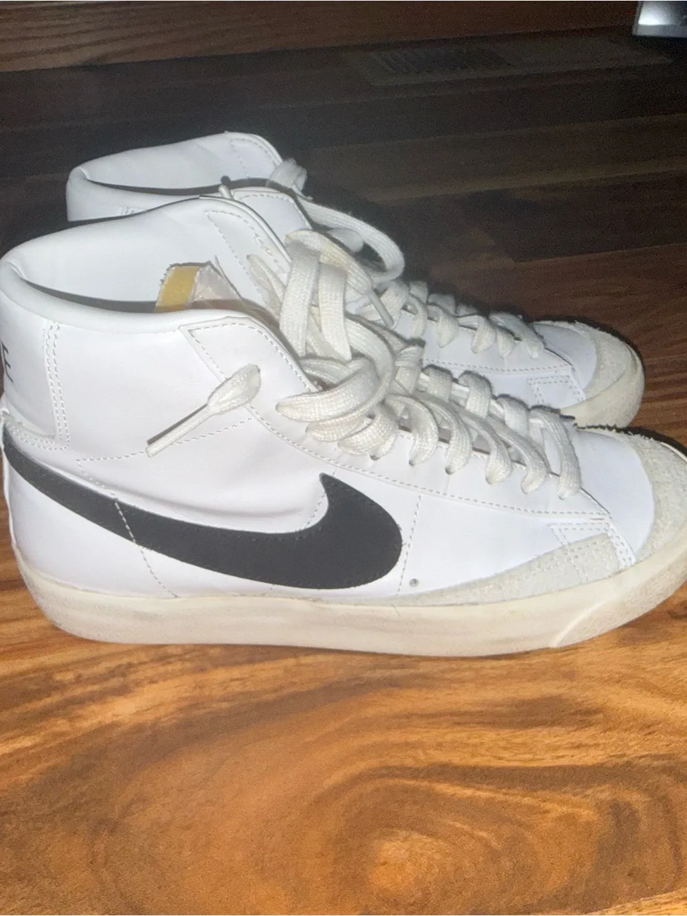 Nike White High-Top Sneakers with Black Swoosh